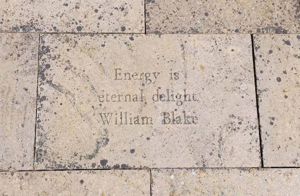 One of the paving stones in our garden that reads "Energy is eternal delight - William Blake"
