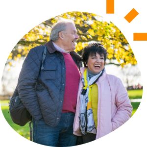 A man and a woman smiling outdoors