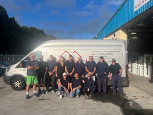 A photo of Bristol Windows staff posing next to a van