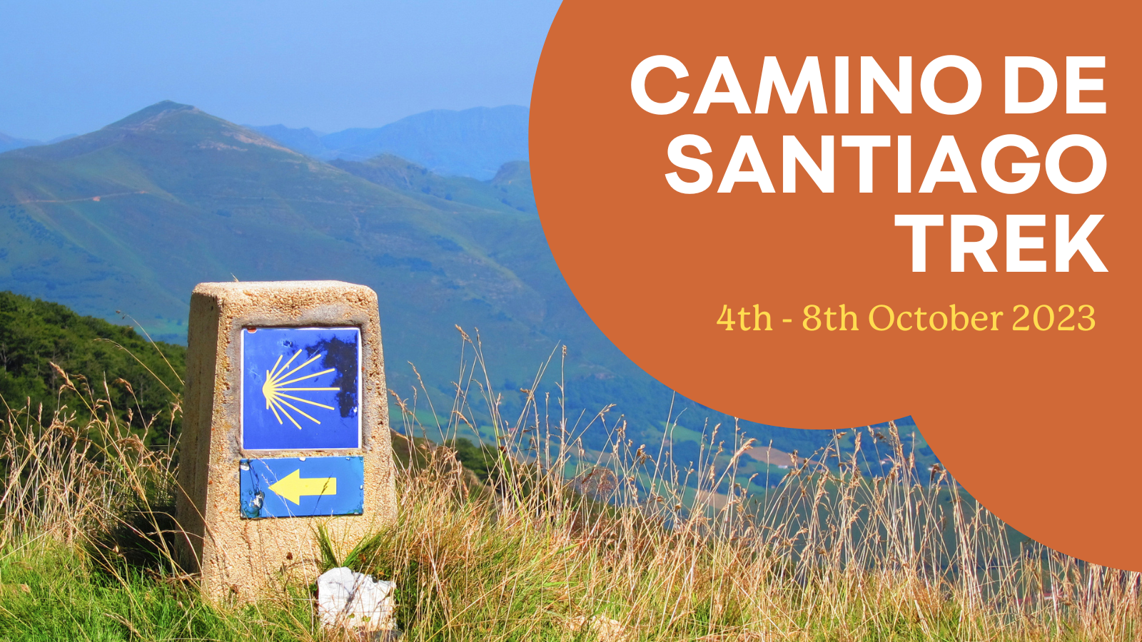 Camino De Santiago Trek. 4th - 8th October 2023. Photo of a marker stone with a blue background and a yellow sun sitting on a grassy hill with a mountain range in the background.