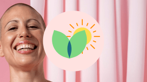A bald woman smiles broadly at the camera