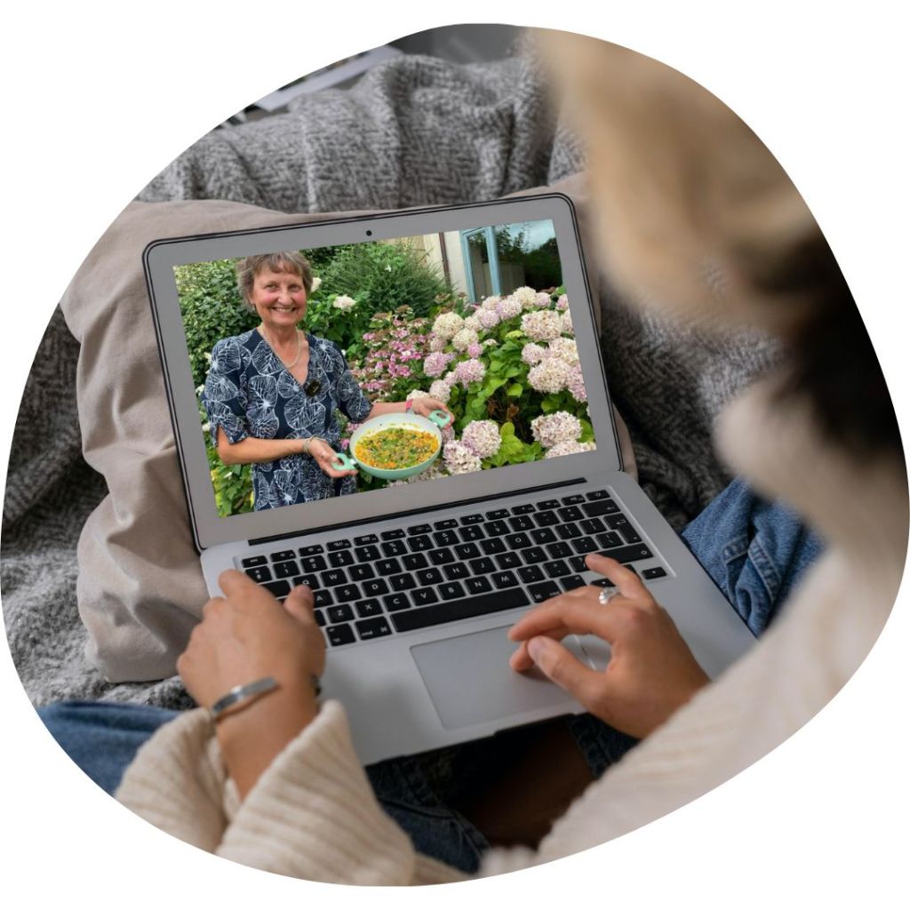 A woman looking at Penny Brohn UK website on a laptop