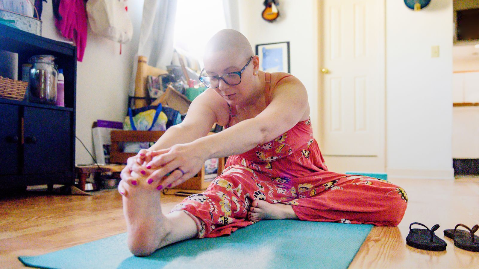 A woman in her home doing yoga
