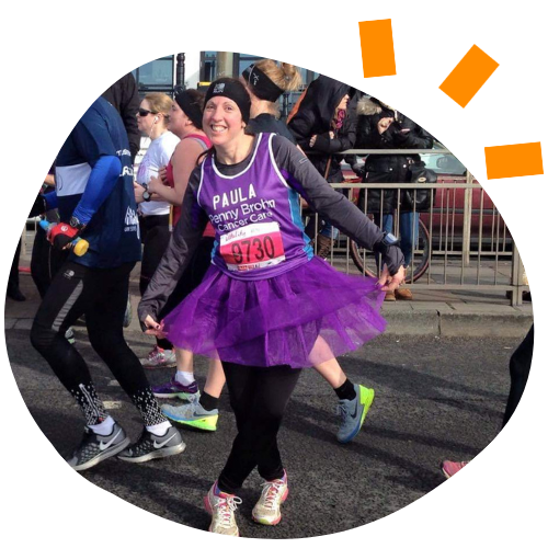 Photo of a woman wearing a purple running vest and purple tutu.