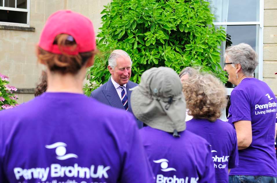 A photo of His Majesty King Charles III talking and laughing with Penny Brohn UK volunteers