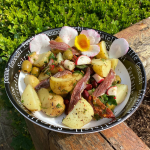 A bowl outside filled with potato salad