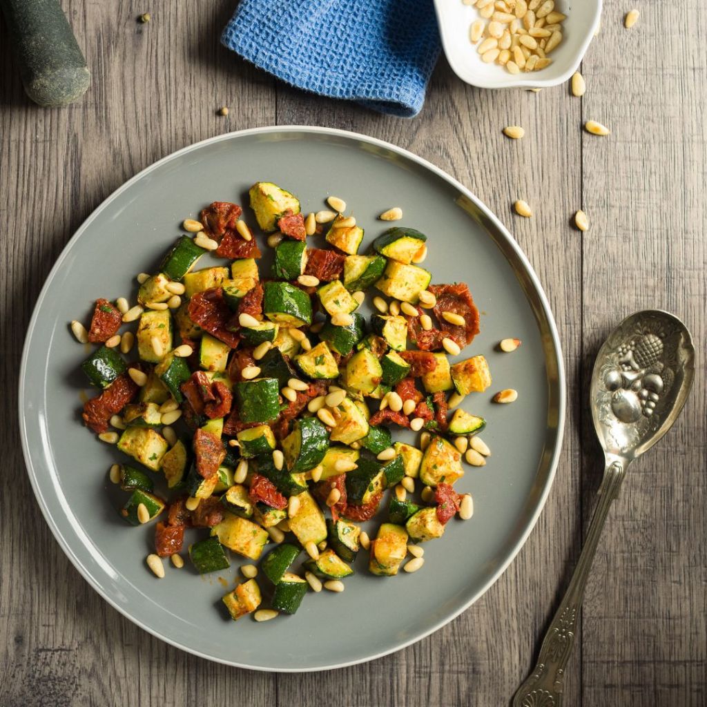 A plate with roast courgette and tomatoes on