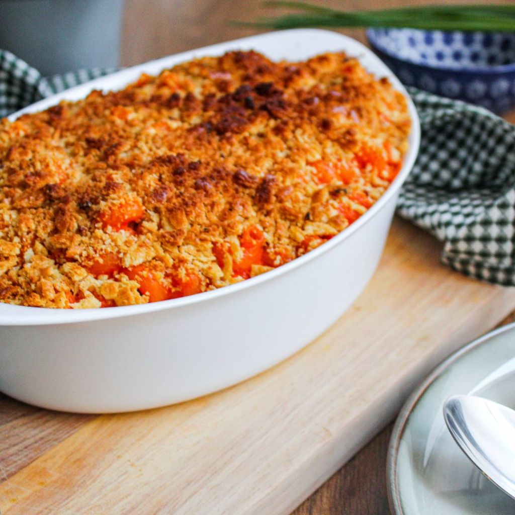 A dish with baked salmon and breadcrumbs on top