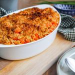 A dish with baked salmon and breadcrumbs on top