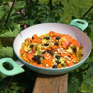 A frying pan in a garden with a Carrot tagine style salad in