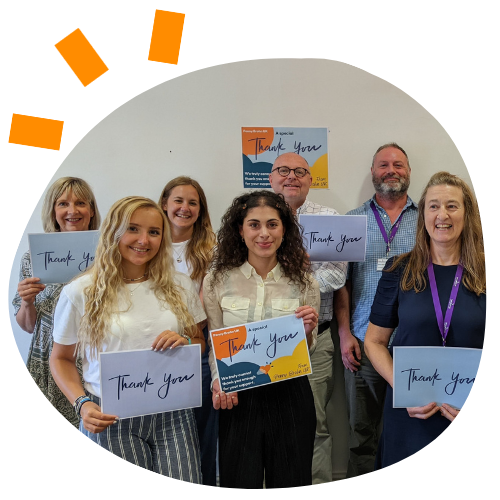 Photo of Penny Brohn UK staff holding thank you signs.
