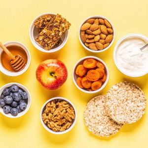 Some healthy snacks in bowls on a yellow table