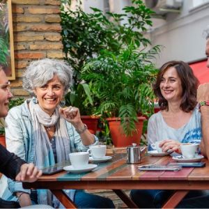 A group of people sat around a table chatting