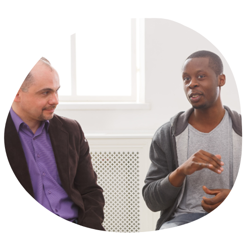 Photo of two men talking in a group session.