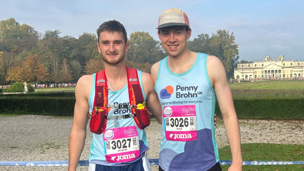 Photo of Louis and Ben, two young caucasian men wearing Penny Brohn UK running vests at the Venice Marathon.