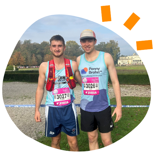 Photo of Louis and Ben, two young caucasian men wearing Penny Brohn UK running vests at the Venice Marathon.