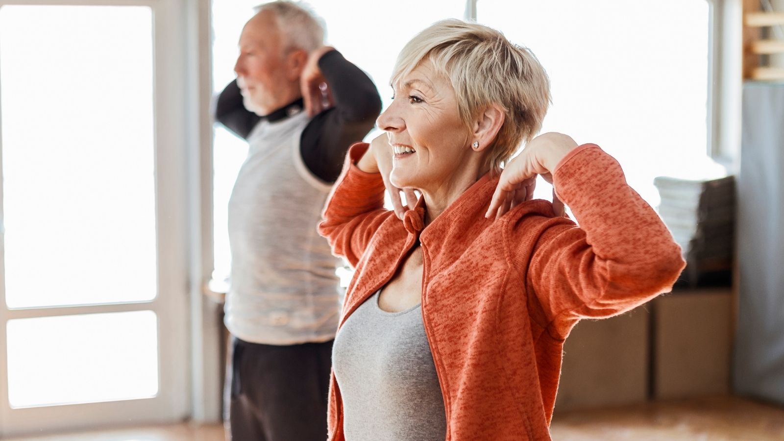 A man and a woman doing exercise in a gym
