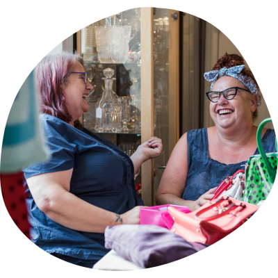 Two women sitting at a table laughing together
