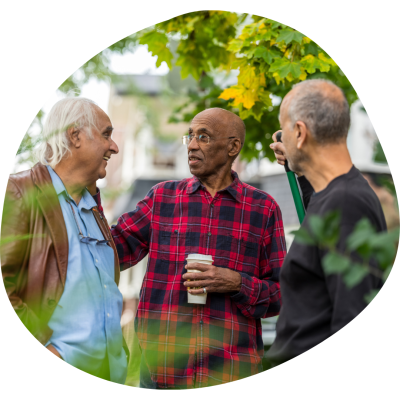 Three men all chatting and standing outside